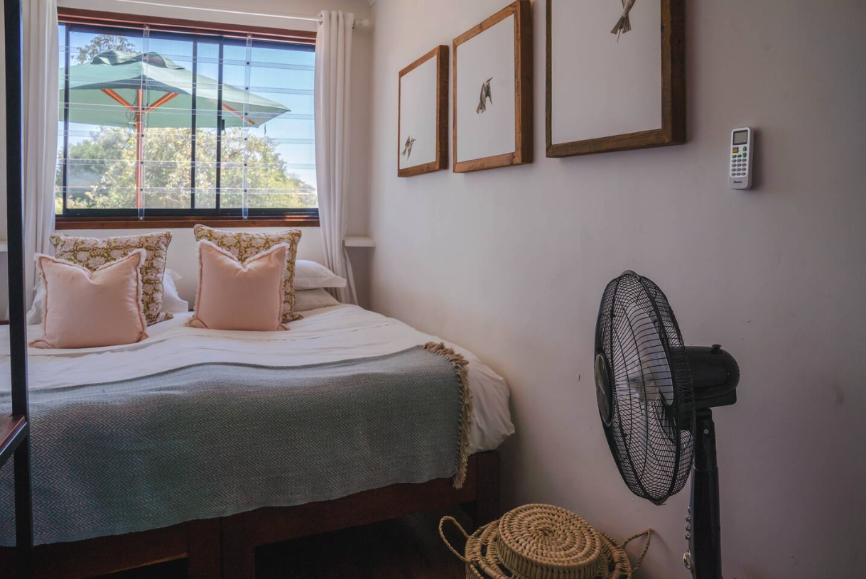 Bedroom with garden view and soft pink linens
