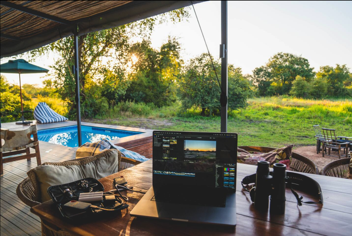 Workspace on the veranda overlooking the pool and bush