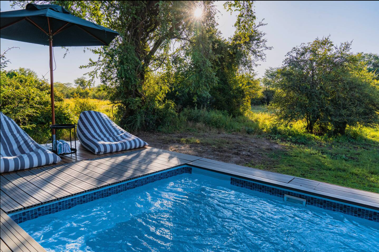 Striped sun loungers beside the pool at golden hour