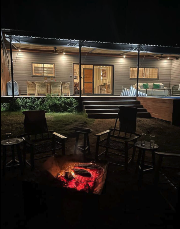 The Bush Box and firepit lit up after dark